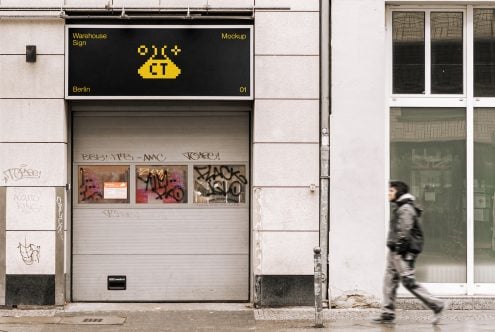 Black warehouse sign mockup on industrial garage door facade
