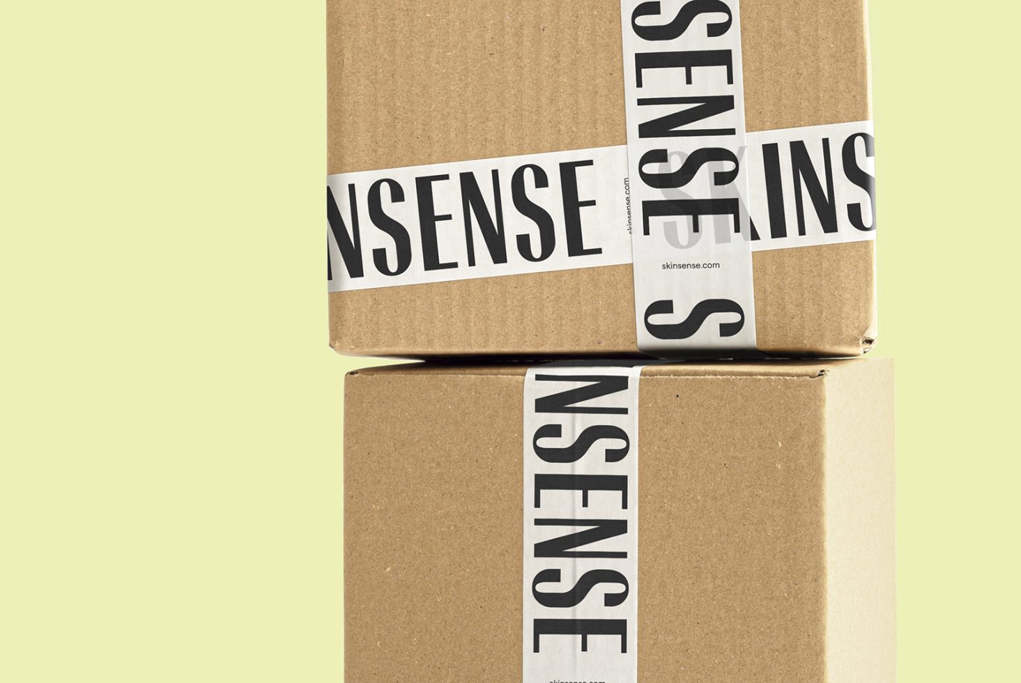 Cardboard packaging box sealed with branded tape mockup against a yellow background, ideal for online store presentation.