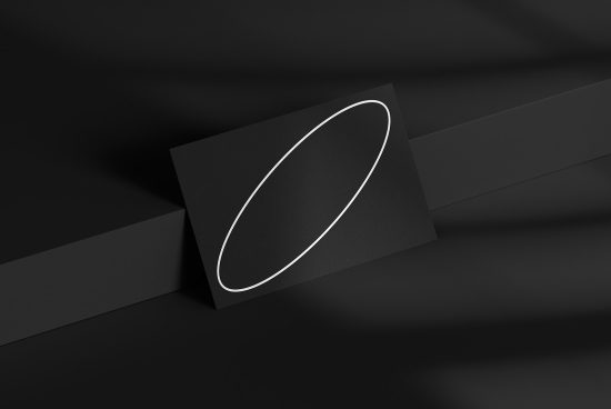 Elegant black business card mockup with white oval branding on a dark textured background, ideal for professional presentation design.