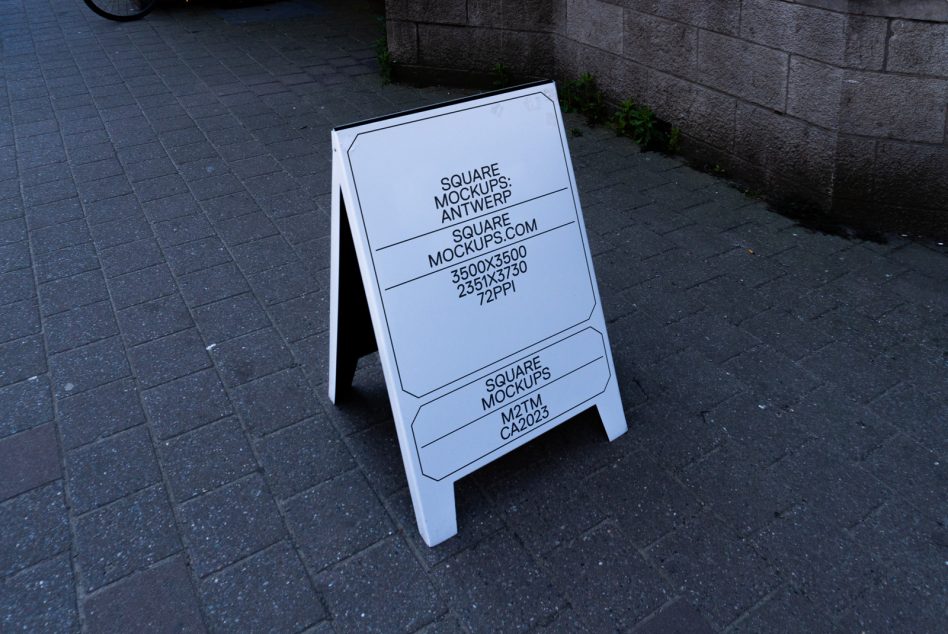 A-frame sidewalk sign mockup in white on dark pavement with rounded corner design