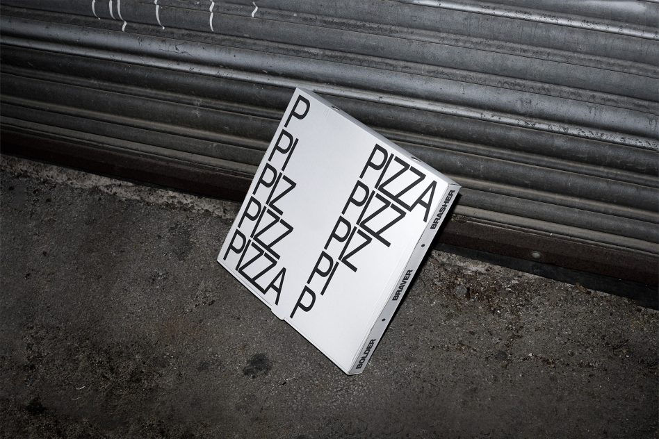 Minimalist pizza typography repeated across white box near metallic backdrop
