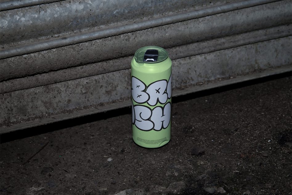Lime green spray can featuring skull design against textured concrete ledge