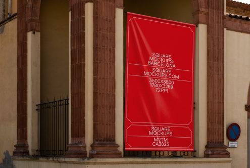 Bright red poster mockup displayed on classical building front entrance