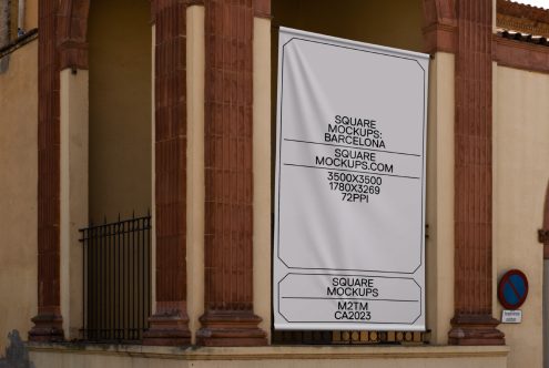 White poster mockup on ornate building entrance between red columns