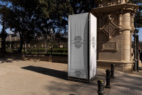 Tall white kiosk structure with square mockup in Barcelona public plaza