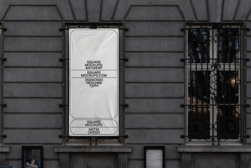 Window display mockup on dark storefront with ornate glass doors