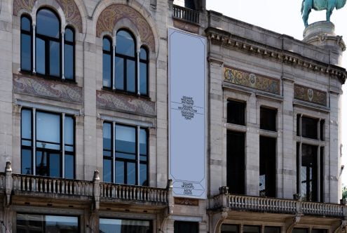 Vertical banner mockup on ornate stone building facade with arched windows