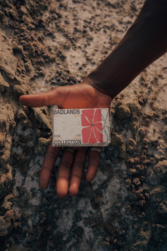 Hand holding card mockup with natural earthy textures, displaying design on a corporate card, ideal for earth-toned branding presentations.