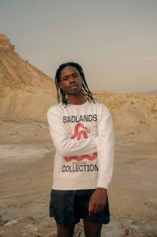 Person wearing cream Badlands Collection sweatshirt in badlands