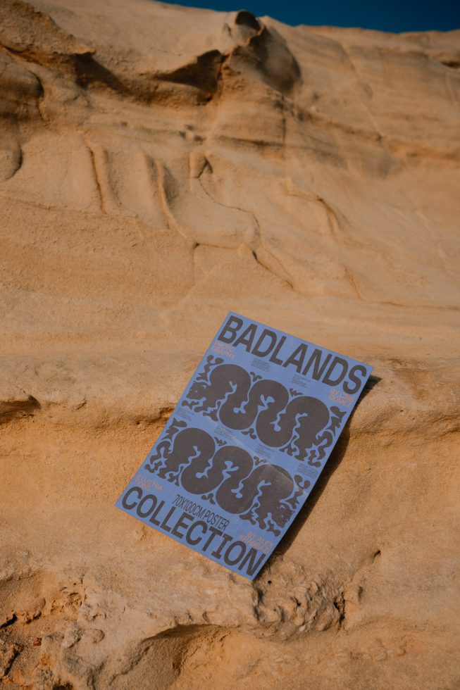 Poster mockup with graphical design displayed on sandy rock surface, showcasing outdoor natural lighting for designers.