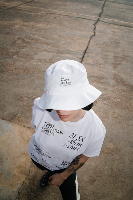 White bucket hat with small logo mockup worn overhead shot on concrete