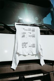 White long sleeve shirt mockup draped on truck windshield in bright sunlight