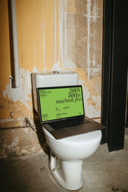 Unique laptop screen mockup on a toilet in a gritty textured bathroom setting, ideal for showcasing unconventional designs and website templates.