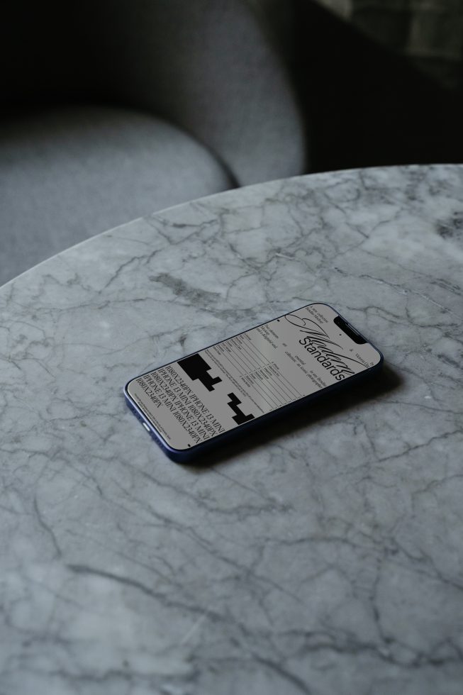 Smartphone on marble surface displaying boarding pass mockup design, ideal for travel-related graphics and UX/UI design presentations.