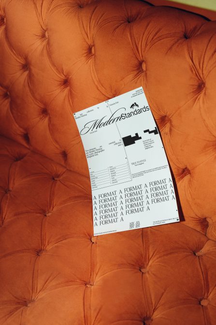 Elegant font showcase on print mockup with Modernstandards font preview aligned on an orange tufted cushion, reflecting sophisticated design.