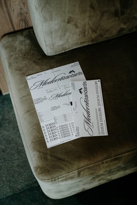 Three printed materials scattered on velvet chair showing Modern Standards collection designs