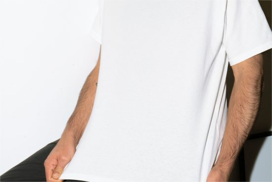 Close-up of a plain white T-shirt on a male model for mockup designs, demonstrating texture and fit, ideal for showcasing graphic apparel prints.