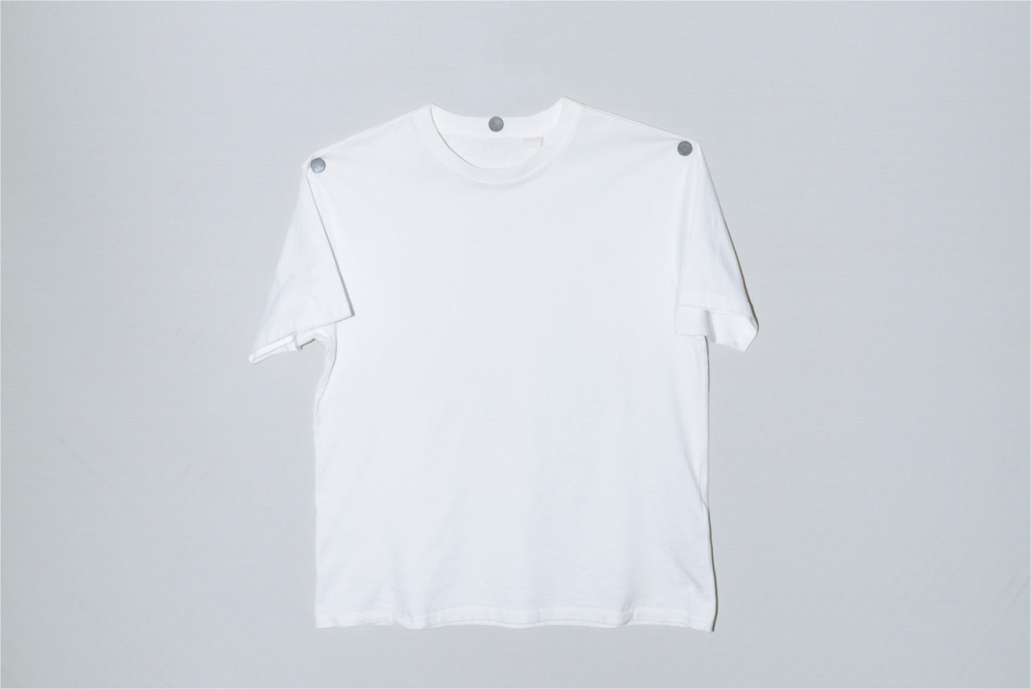 Plain white t-shirt mockup on a simple background, perfect for apparel design presentations and branding projects.