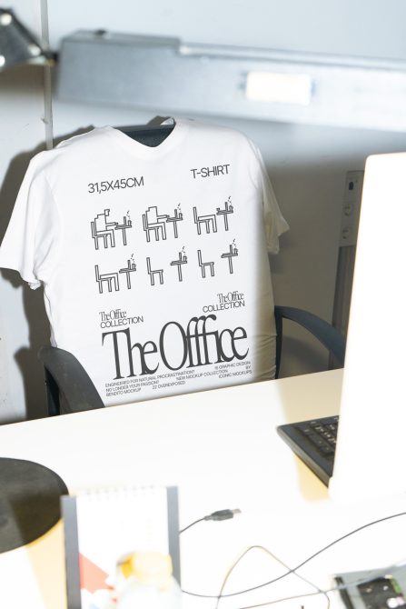 T-shirt mockup hanging on chair back in minimal office workspace