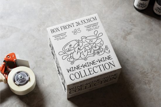 Mockup of a wine collection box with artistic doodles and text on a concrete surface, surrounded by packaging tools, ideal for branding presentations.