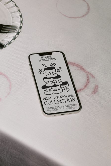 Smartphone on table displaying graphic design wine collection mockup, highlighting template versatility for designers.