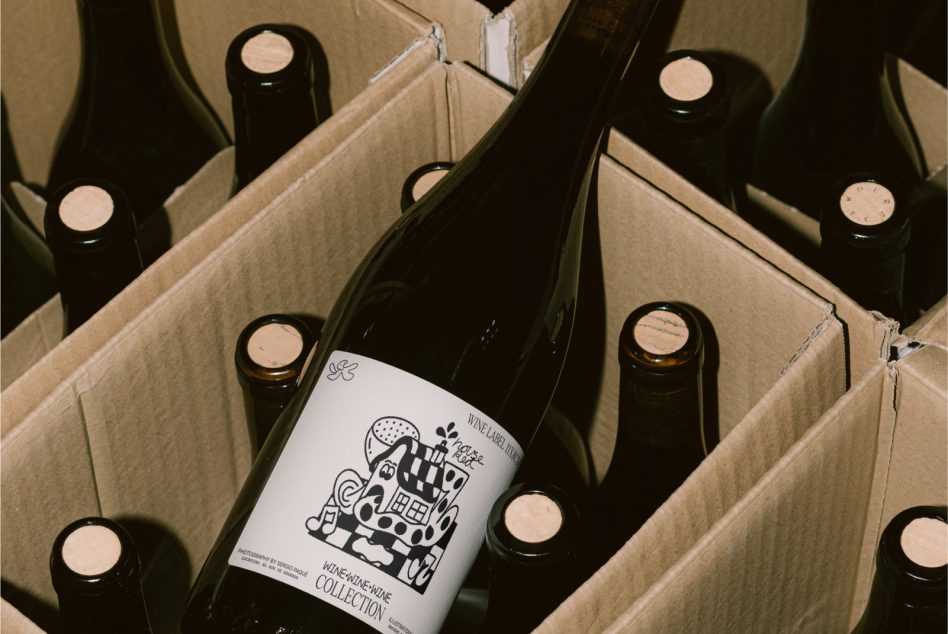 Wine bottles in cardboard box with illustrated label design on center bottle