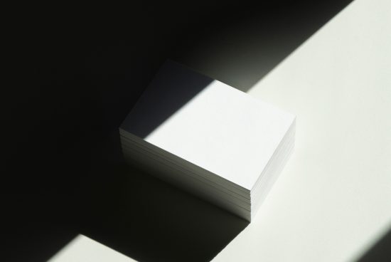 Stack of blank business cards with natural shadows, ideal for mockup designs, graphic templates, and brand visualization.