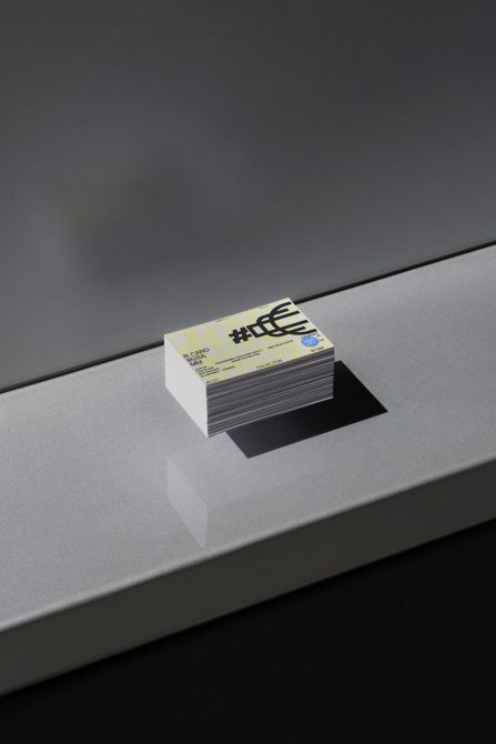 Stack of business cards with modern design on shiny surface for mockup graphics display, showcasing contemporary typography and branding