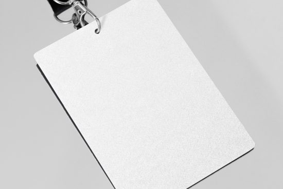 Blank white paper tag mockup with metallic binder clip, isolated on gray background, ideal for branding presentation and design showcase.