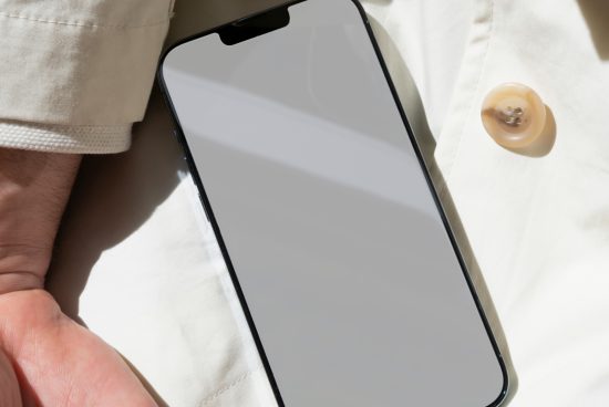 Smartphone mockup with blank screen on fabric surface for app design presentation, digital mockups for designers.