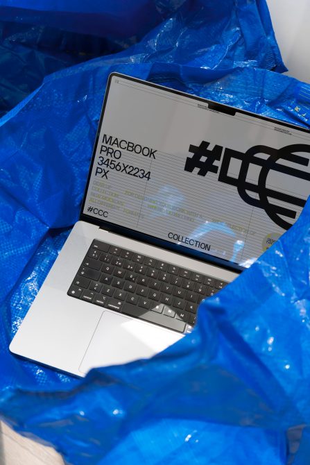 Laptop screen mockup with bold hashtag graphic surrounded by blue plastic, showcasing sleek design for digital asset templates.