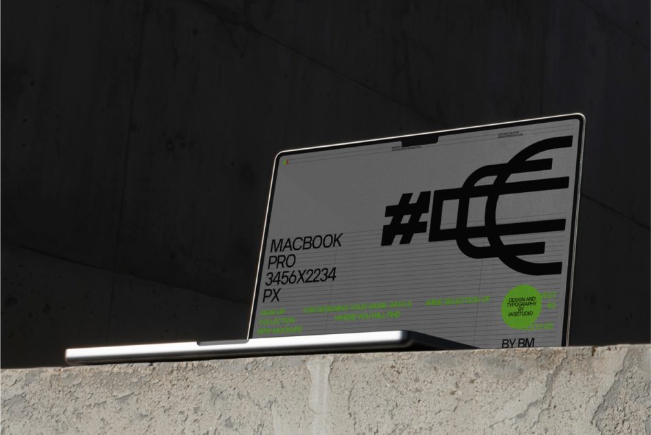 MacBook Pro mockup displaying geometric design with neon green accents on concrete surface
