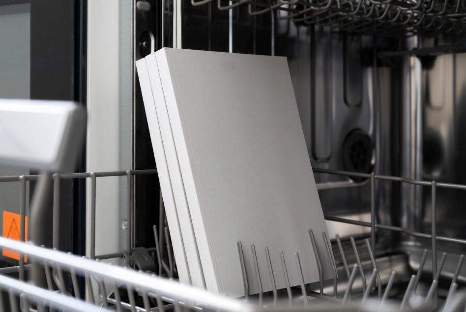 Blank book mockup in dishwasher, clean minimal design, showcasing graphic templates for portfolio presentations.