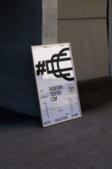 70x100cm poster mockup leaning against concrete wall with bold black symbol