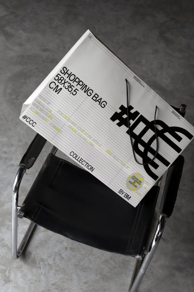 Unique shopping bag mockup on chair, with label design elements, concrete background, suitable for presentation and design showcases.