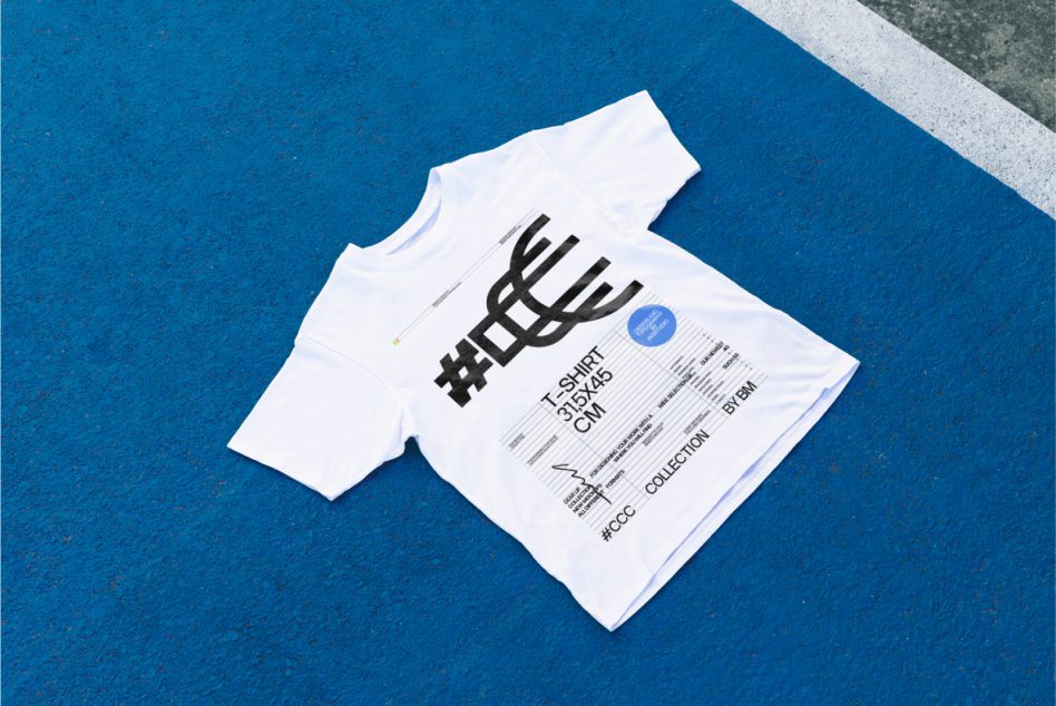 White tee with bold black hashtag logo on blue textured background