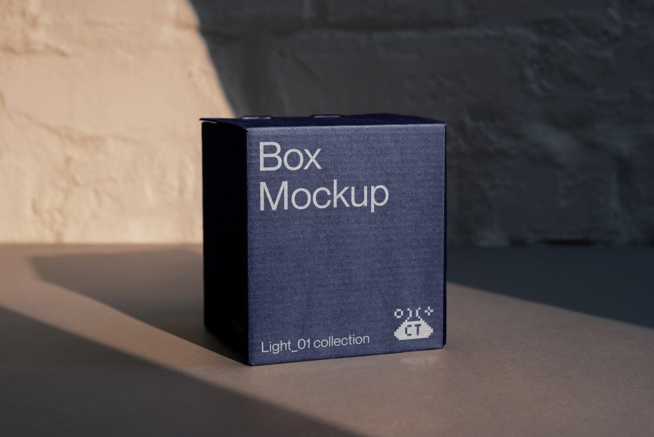 Navy blue cube box mockup sitting in natural sunlight casting sharp shadow