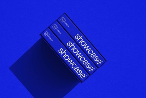 Three blue book spines in black box on vibrant blue background tilted