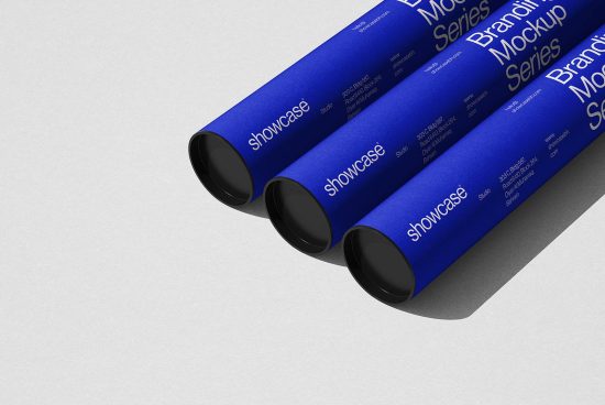 Blue poster tubes mockup with branding text, designers' asset for presentation, laying diagonally on light background for mockups category.