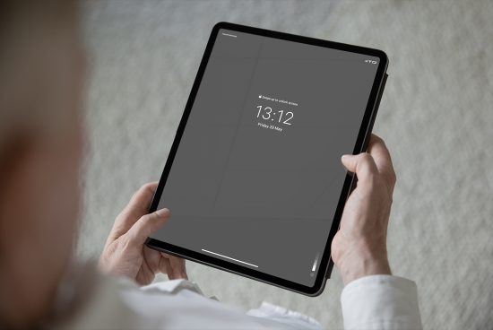 Person holding tablet mockup with blank screen for design presentation, digital device template for user interface display.