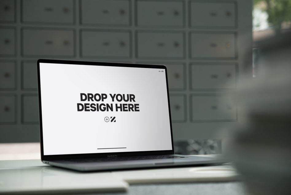 MacBook Pro laptop on desk with white screen design template