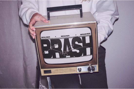 Person holding a vintage television displaying bold text design, blending retro aesthetics with modern typography, ideal for templates.