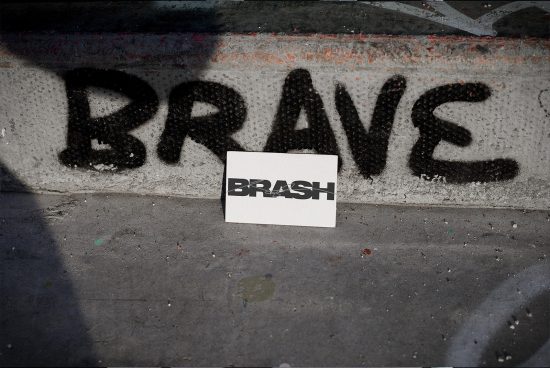 Urban street poster mockup with the word BRASH on a wall featuring bold stencil graffiti art, ideal for designers to present branding designs.