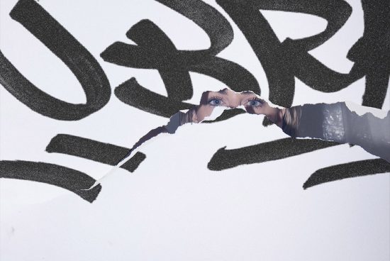 Creative close-up of hands ripping paper with graffiti revealing eyes, ideal for mockup or graphic design inspiration.