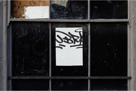 Graffiti tag mockup on urban windowpane with weathered textures, ideal for designers to display street art or typographic designs.