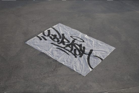 Graffiti style font on urban concrete floor, versatile for mockups, trendy urban asphalt texture, graphic design asset.