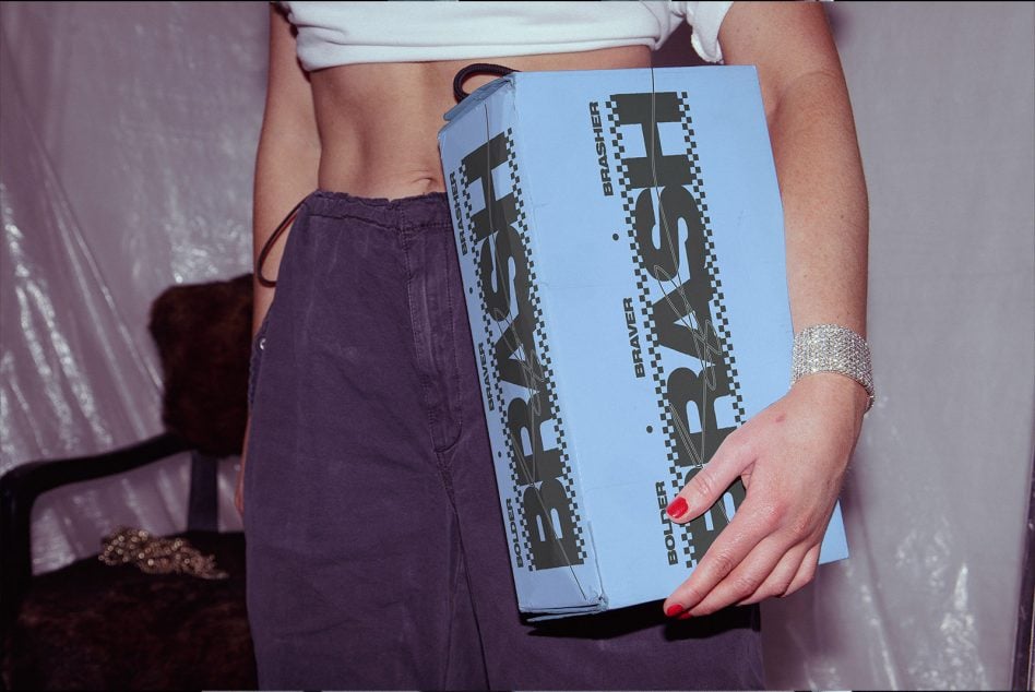 Light blue BRASH clutch showing checkered detail on side