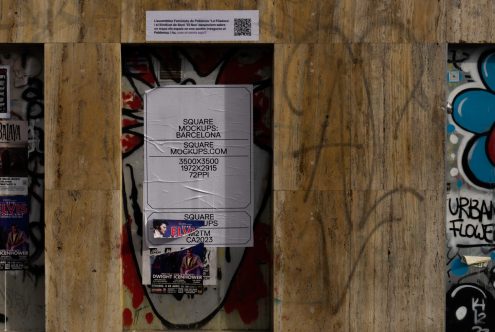 Single white square poster mockup on weathered wood door with graffiti