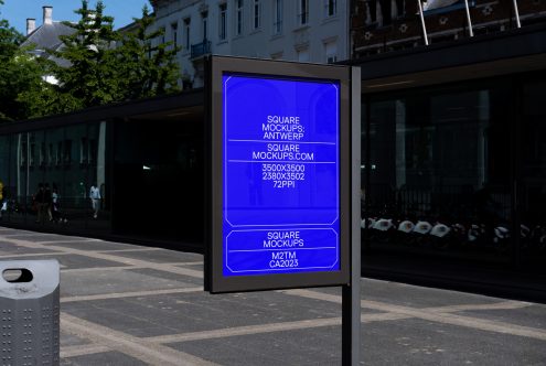 Glowing blue poster mockup on black kiosk in busy pedestrian area