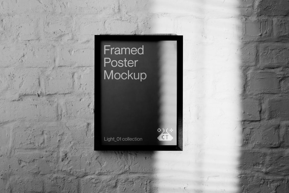 Black framed poster mockup with dark interior hanging on white brick wall